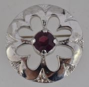 A vintage white metal brooch with pierce