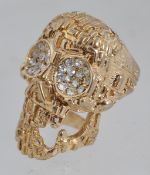 A large yellow metal dress ring in the f