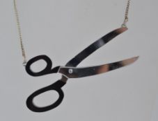 A white metal necklace with mirrored sci