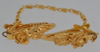 A vintage 1950s gold tone sweater guard,