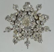 A vintage white metal brooch pin in the