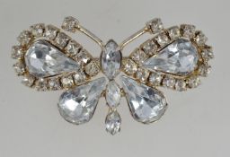 A vintage white metal brooch pin in the