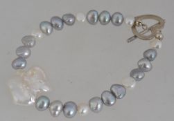 A white metal and baroque pearl bracelet