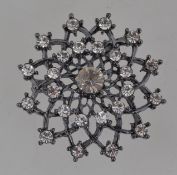 A vintage oxidized metal snowflake brooc