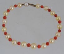A vintage pearl and coral bead bracelet