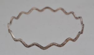 A 925 silver bangle in a planished wave