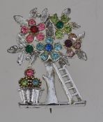 A vintage white metal figural brooch in