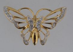 A vintage yellow metal figural brooch in