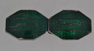 A white metal Art Deco French cloak clip