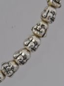 A white metal budda bead necklace with l