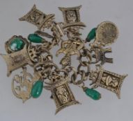 A vintage yellow metal charm bracelet wi