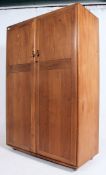 A stunning light beech and elm wood Ercol two door ' Windsor pattern ' wardrobe,