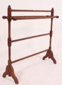A Victorian mahogany towel rail stand with finial tops having hexagonal rails to centre.