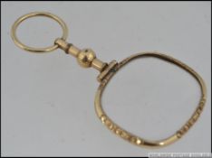 Early 20th Century yellow metal puzzler eye glass.