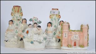 A pair of 19th century Staffordshire flatback ceramic candlesticks figurines along with two others.