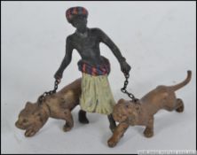 A good cold painted bronze of two lions being led by a Blackamoor lion tamer