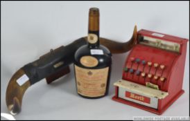 A vintage tin plate mid century childs toy till by Merit together with a retro Courvoisier ice