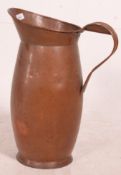 A large floorstanding copper jug of baluster form with scrolled handle - ideal as an umbrella -