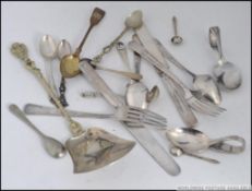 A collection of silver hallmarked and silver plated flatware to include hallmarked Georgian tea