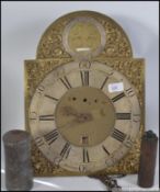 A long cased clock face and movement in brass with roman numerals and date square .