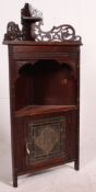 A Victorian mahogany corner cabinet with leaded glass cabinet door to base and fret worked gallery