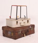 A good leather early 20th century suitcase together with a white vinyl 1950's suitcase by Airport.