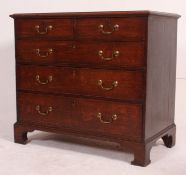 A 19th century Georgian country oak 2 over 3 chest of drawers being raised on bracket legs with 2