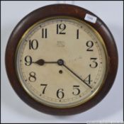 A mid century oak cased station wall clock marked ANVIL to white enamel face .