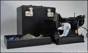A 20th century vintage Singer Featherlite 221K sewing machine complete in the original carry case