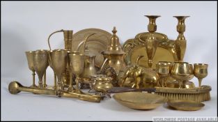 A collection of vintage 20th century brasswares to include candle sticks, drinking beakers,
