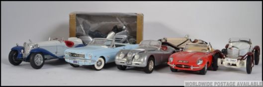 A collection of scale model cars by Burago to include Ford Mustang,