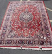 A early 20th century Kashan - Iranian style rug / carpet with deep red ground interspersed with