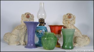 2 Staffordshire ceramic dogs together with a collection of studio pottery, an oil lamp,