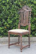 A Victorian carved oak Carolean revival hall chairs raised on barley twist supports with shaped