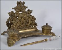 A Victorian brass rococo desk tidy inkwell.