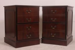 A pair of antique style mahogany and leather pedestal filing cabinets.