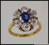 An 18ct gold diamond and sapphire cluster ring with approx 90pts diamonds with central cushion cut