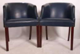 A pair of vintage 1950's working mens club armchairs raised on mahogany squared legs with blue