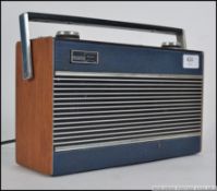 A vintage mid century Roberts portable radio having teak and blue vinyl case and facia