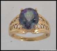 A hallmarked 9ct gold dress ring with large central oval cut synthetic alexandrite in a prong