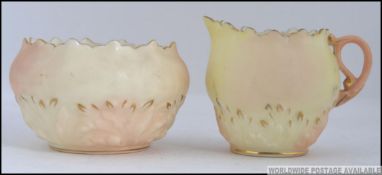 A Locke & Co Worcester sugar bowl and creamer both having blushed ivory ground with gilded