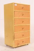A vintage 1950's painted yellow wooden pedestal chest of drawers having an upright bank of drawers