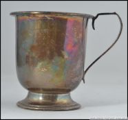 A silver hallmarked tankard having scrolled handle.