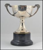 A silver hallmarked trophy on ebonised plinth.