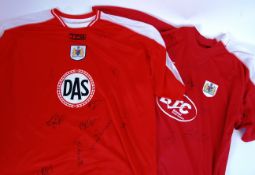 BRISTOL CITY: Two fully signed Bristol City Football CLub shirts.