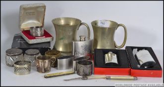 A dealers lot to include silver top glass pots, silver plated tankards, plated boxed hip flasks,