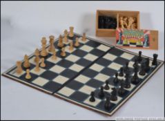 A vintage mid century boxed boxwood chess set together with another chess set and a folding board