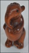 A hard wood Japanese ornately carved Netsuke of a standing elephant.