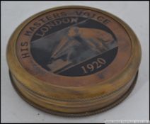 A 20th century HMV brass and copper compass set within a leather case.