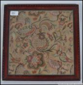 A framed and glazed 19th century tapestry sampler, of floral geometric design.